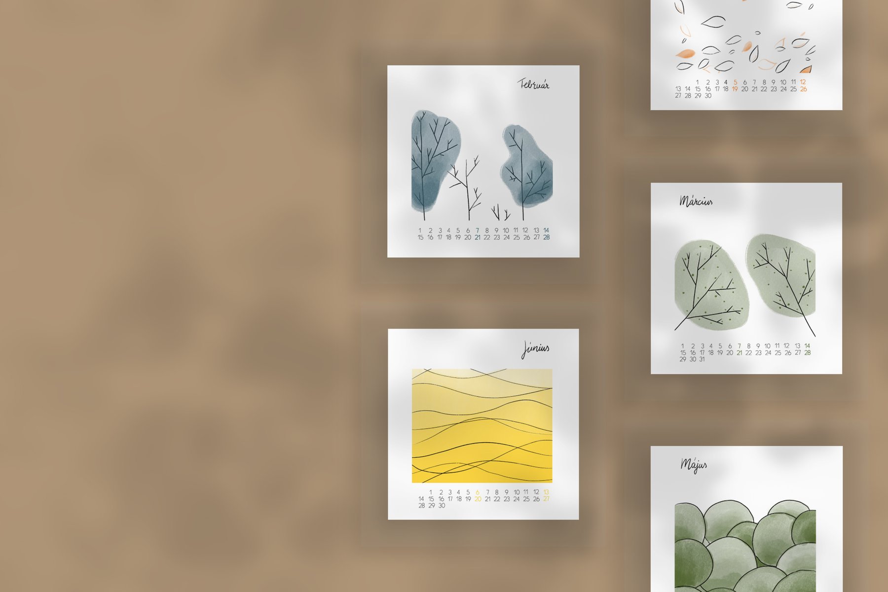 Pages of the 2021 calendar pinned to a warm brown wall