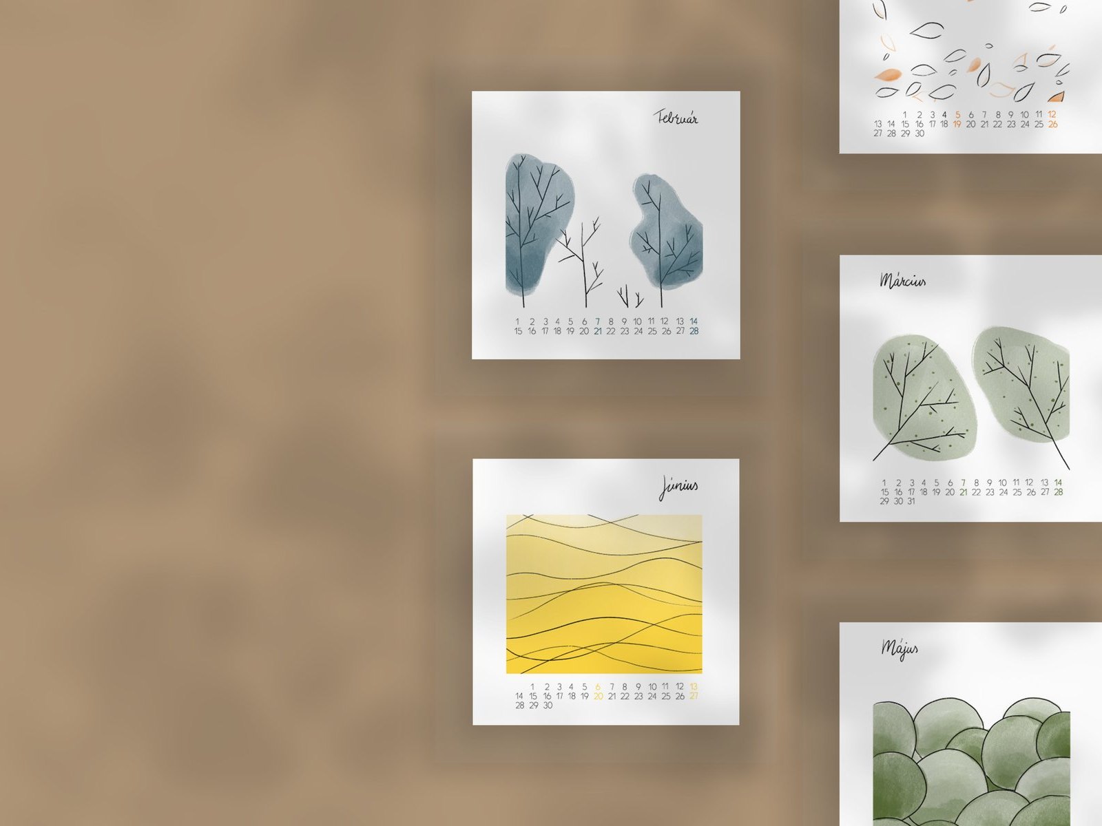Pages of a nature-illustrated calendar on a brown wall