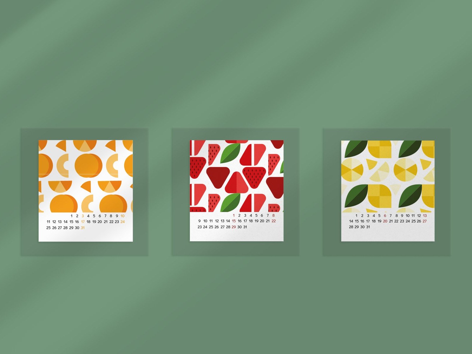 Three geometric fruit pattern calendar pages on a green wall