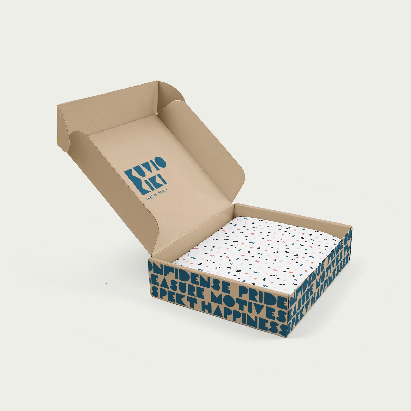Open kraft mailer box with the Kuvio Kiki logo inside the lid, patterned tissue paper and a word pattern printed around the sides