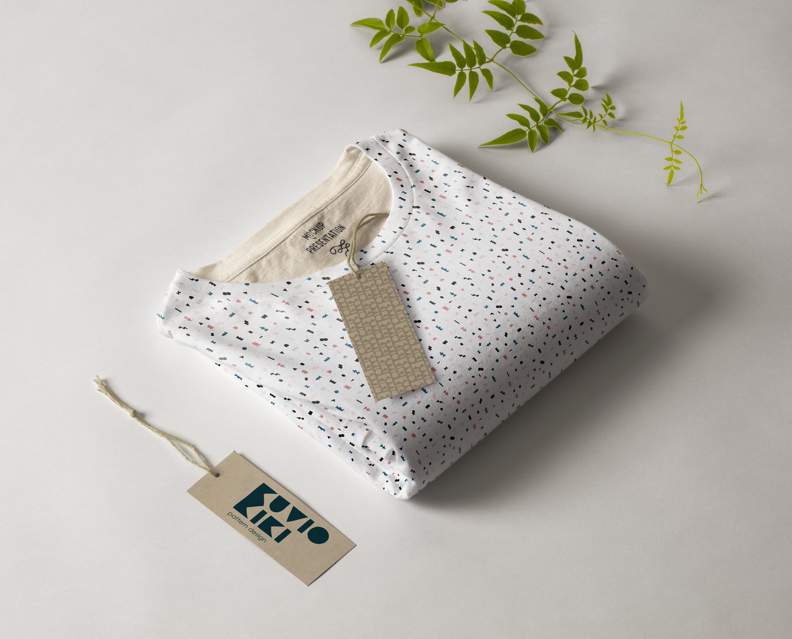 Folded T-shirt in the confetti pattern with a Kuvio Kiki hang tag