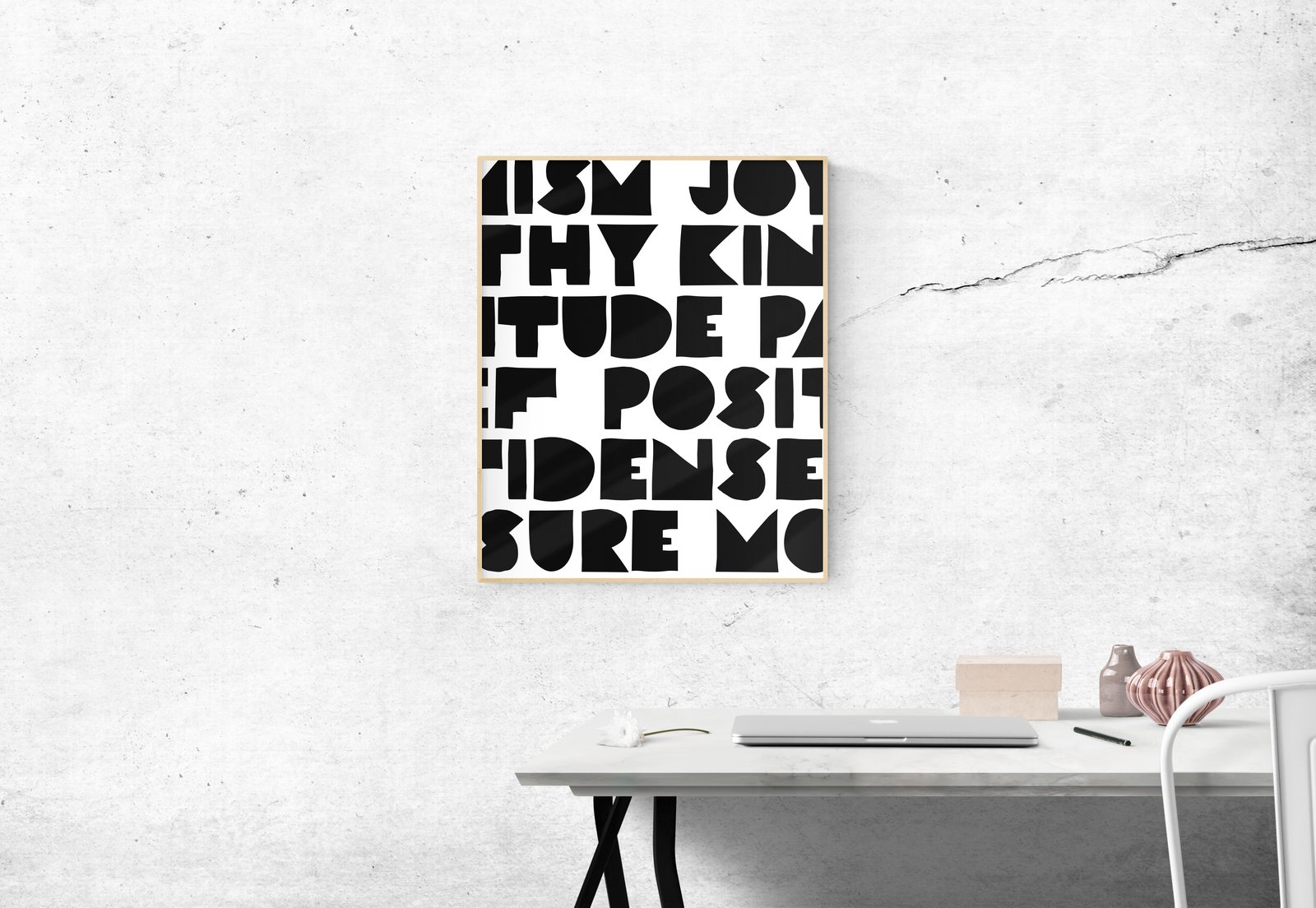 Framed word pattern print above a desk