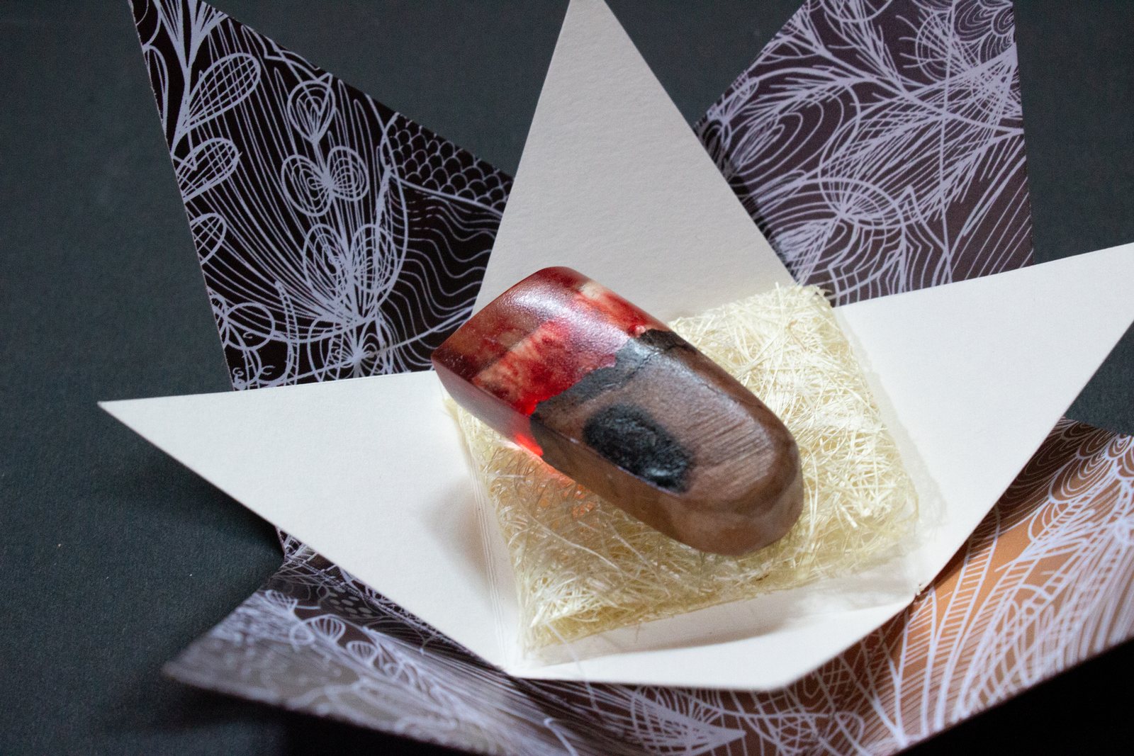 Close-up of a resin ring in its box
