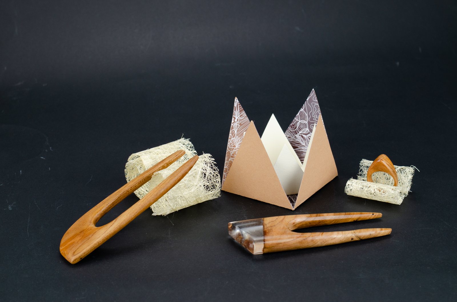 Wooden hairpins next to the boxes