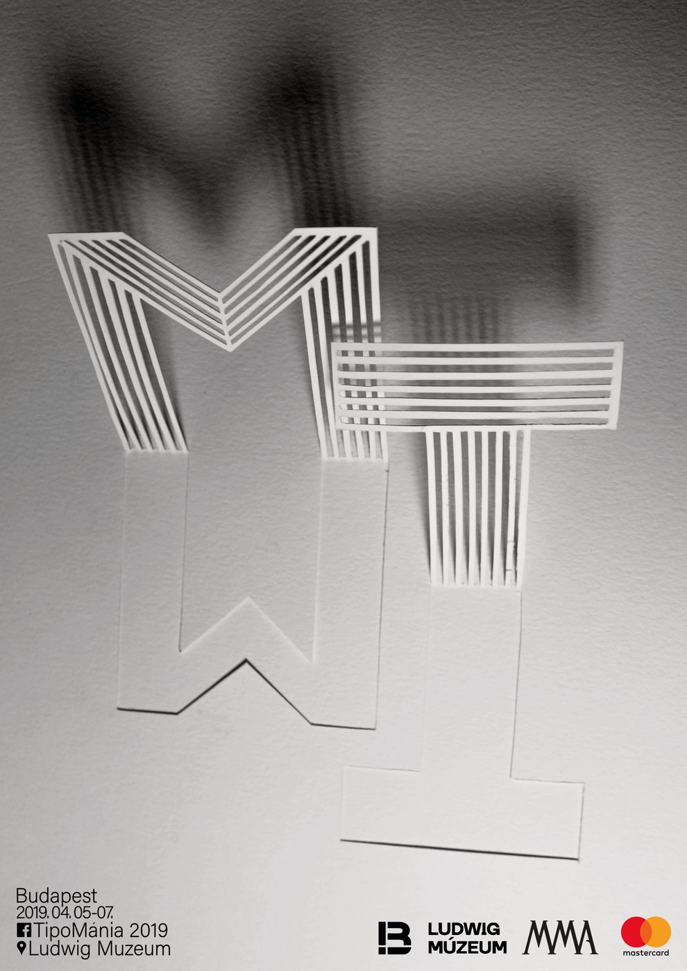 TipoMánia 2019 poster: paper letters in soft grey
