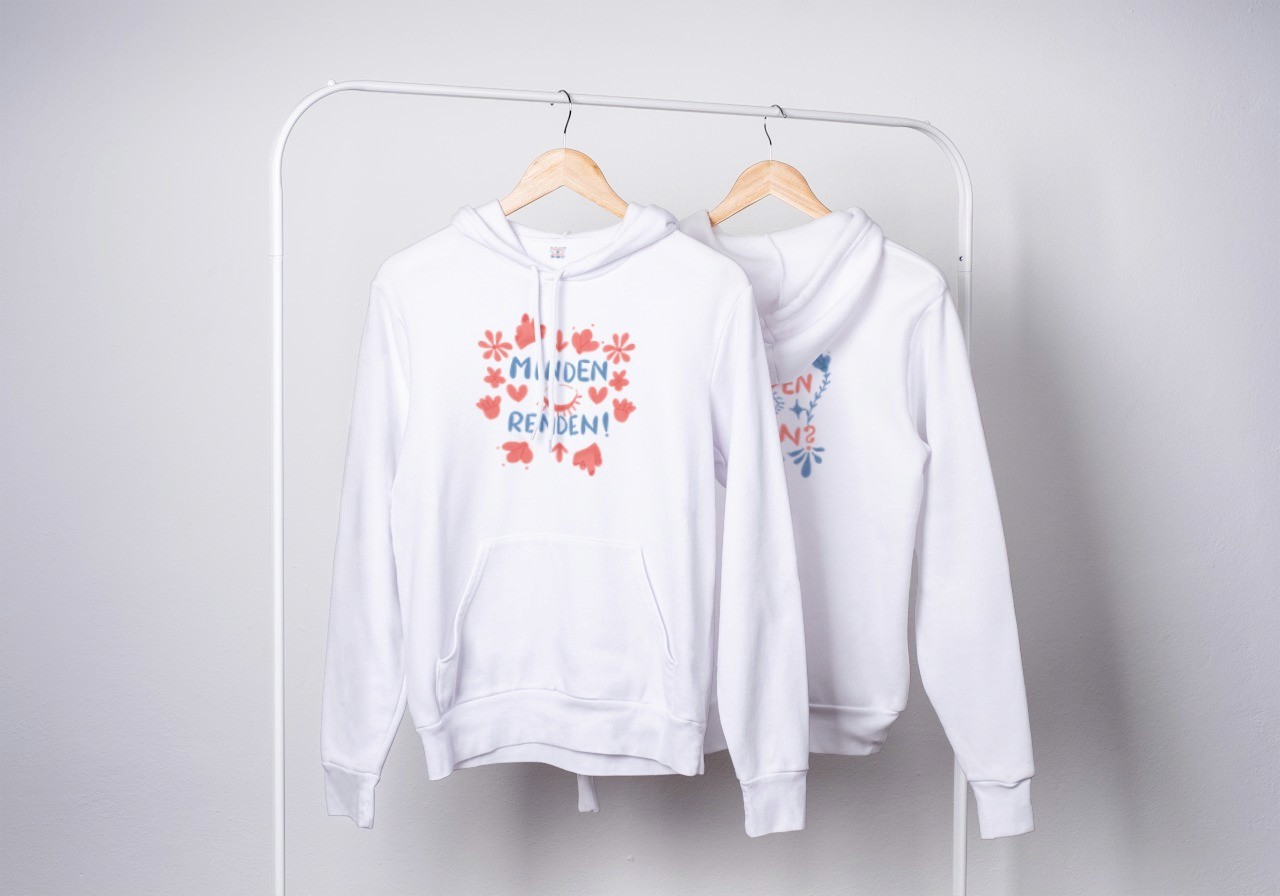 Sweaters with the merch designs on a rail