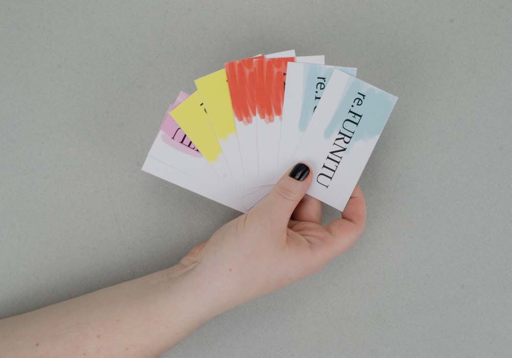 A fan of business cards held in a hand