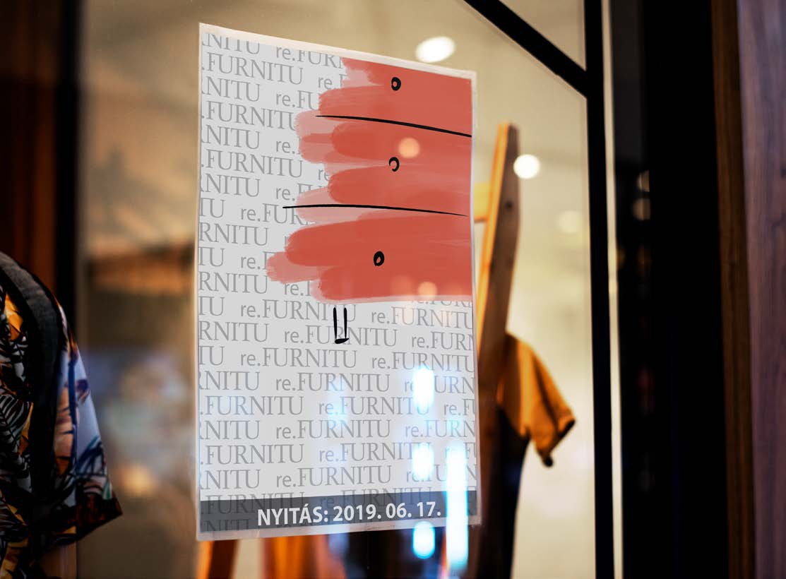 The coral cabinet poster in a shop window