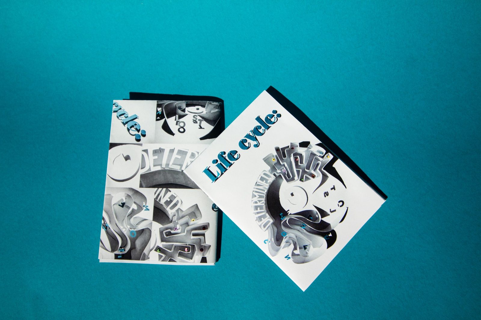 Front and back cover of the printed zine on teal